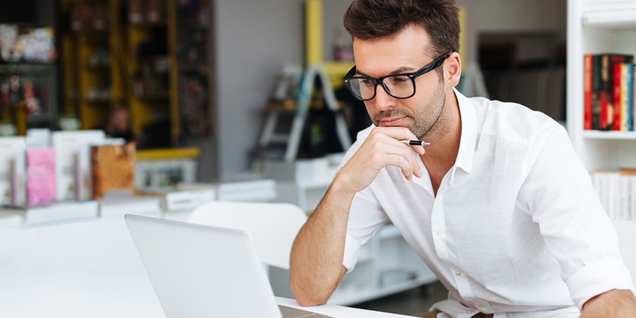 a man works in an office on his laptop