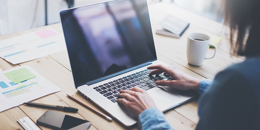 a picture of hands working on a laptop