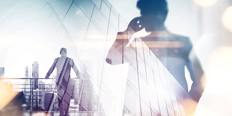 a man talking on the phone with a skyscraper background