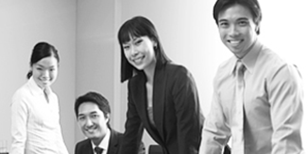 A diverse group of professionals smiling and posing for a photo.