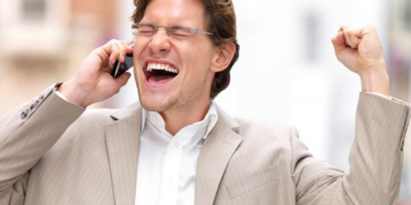 Man in formal attire speaking on his mobile phone.